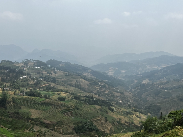       Wide view of terraced valleys and mountains.
  