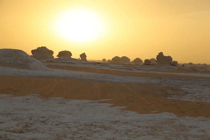 Desert with unique rock formations at sunset.
