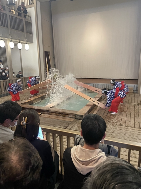       People performing a traditional hot spring activity
  