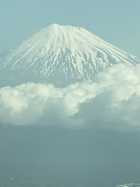 Snow-capped mountain peak above clouds
