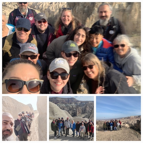 Group of people taking a selfie with rock formations in the background.