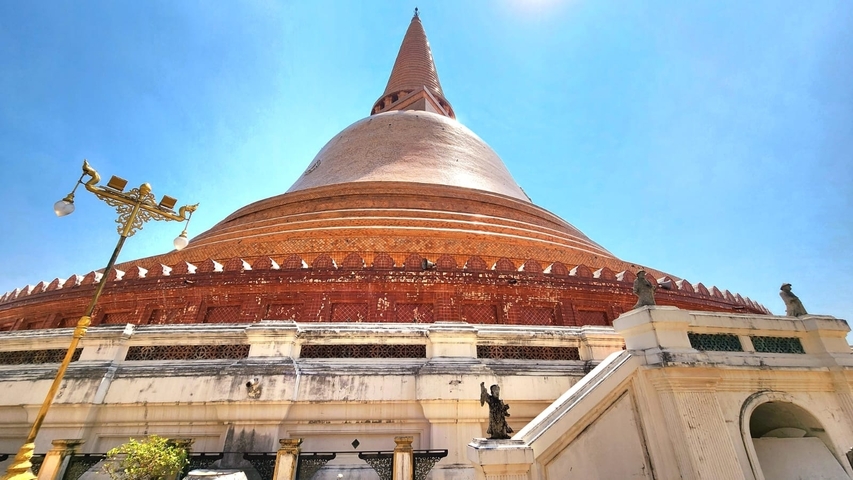 A large stupa against a clear blue sky.