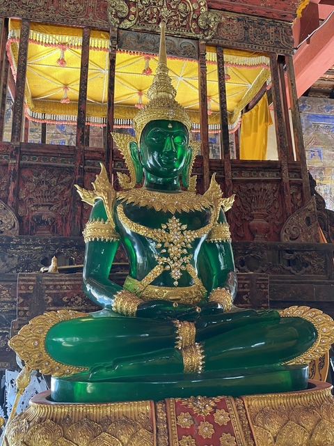       An emerald Buddha statue adorned with gold.
  