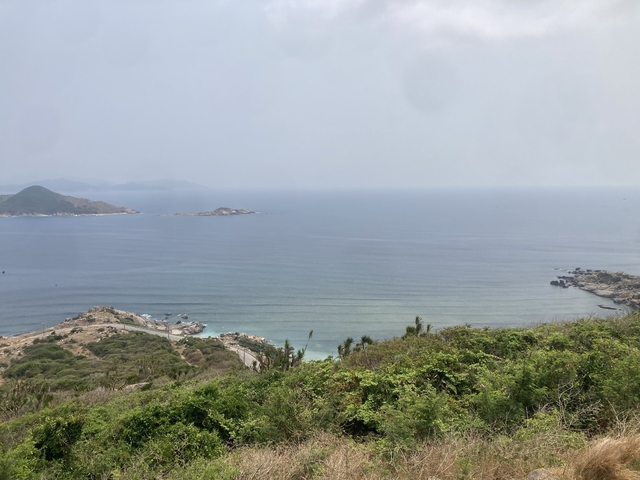       Aerial view of the sea with rocky coastline.
  