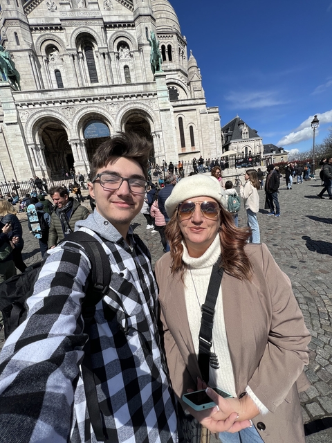 Couple taking a selfie in front of a historic church