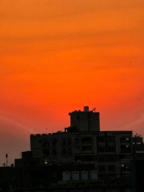       Skyline view at sunset with an orange-red sky.
  