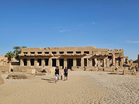 Karnak Temple ruins with tourists exploring the site.