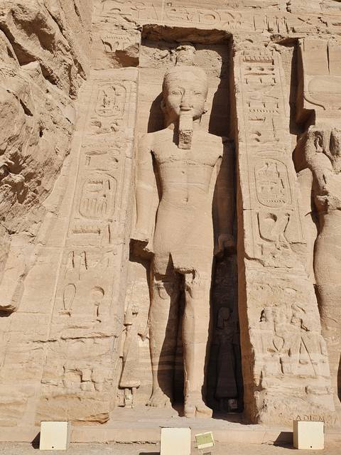       Stone carving of a standing pharaoh.
  