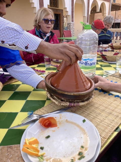       Moroccan tajine pot being served.
  