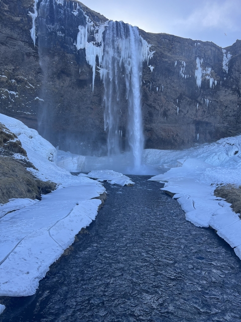       Frozen waterfall surrounded by snow and ice.
  