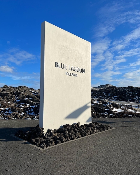       Blue Lagoon entrance sign surrounded by lava rock.
  