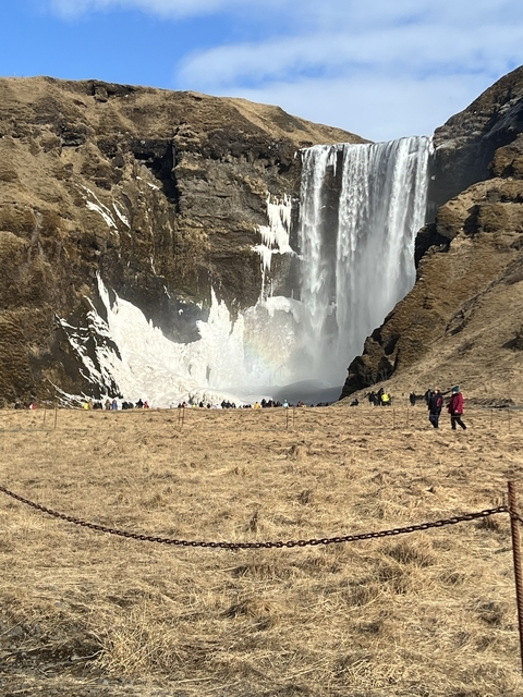       Large waterfall with people in the foreground.
  