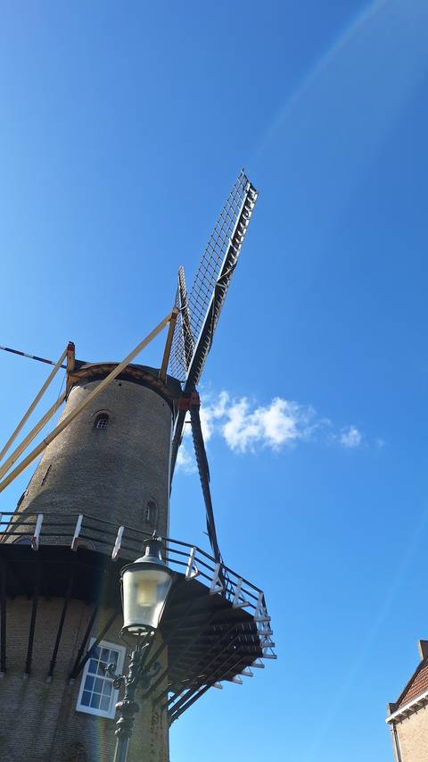 Traditional windmill under a clear sky.