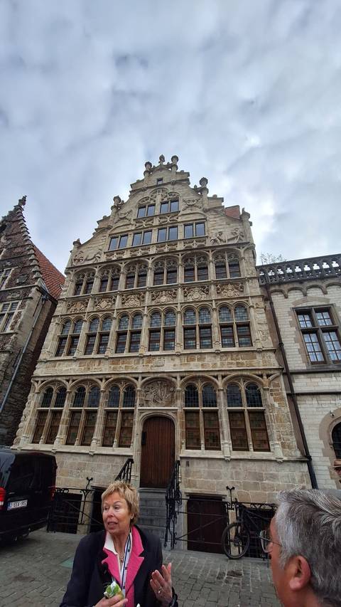 Historic building facade with people.