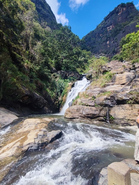       Small waterfall flowing over rocky terrain.
  