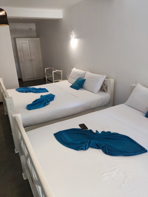 Hotel room with two neatly made beds.