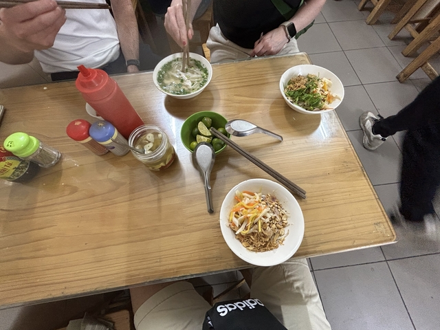 Variety of dishes laid out on a wooden table.