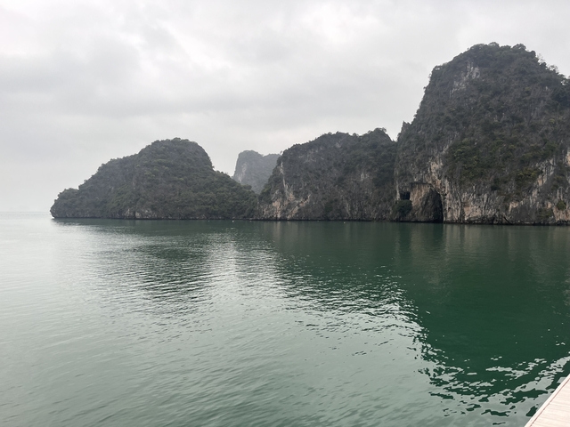 Scenic view of limestone karsts over a body of water.