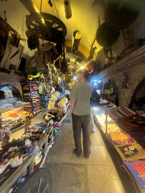       A man browsing items in a market.
  