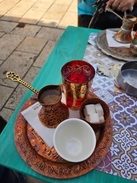       Traditional coffee set with colorful patterns on a table.
  