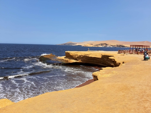       Rocky coastline with waves crashing against the shore.
  