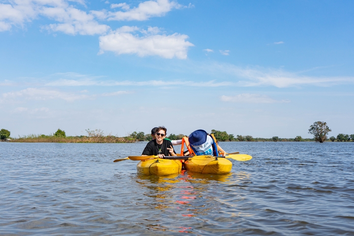 Two people kayaking on a lake.