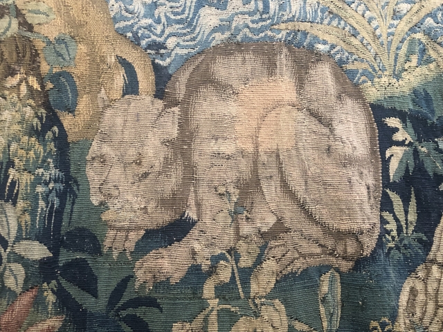       Intricate tapestry with animal figures.
  