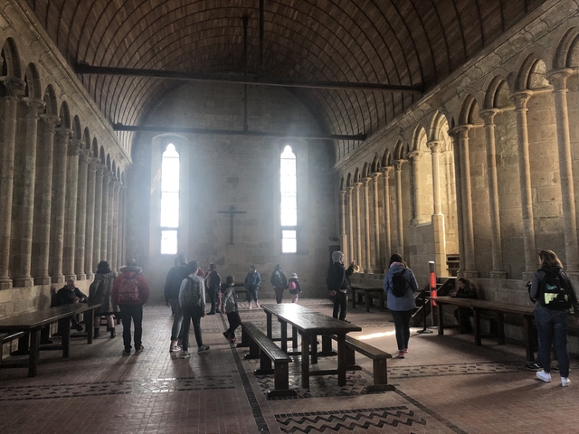 Interior of an ancient church with visitors.