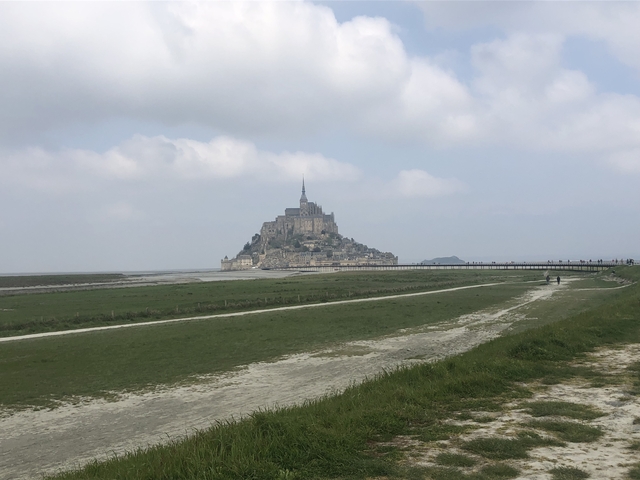 Mont Saint-Michel on an island with tidal causeway.