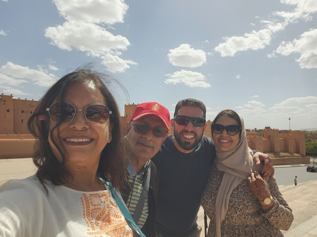 Group selfie with desert landscape in the background.