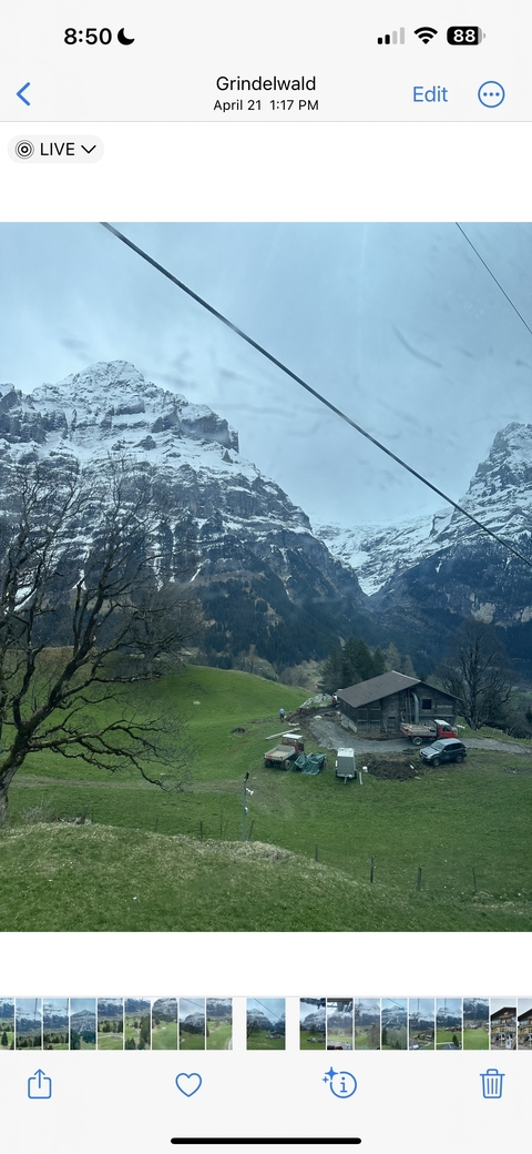 Snow-capped mountains with a cabin near the base.