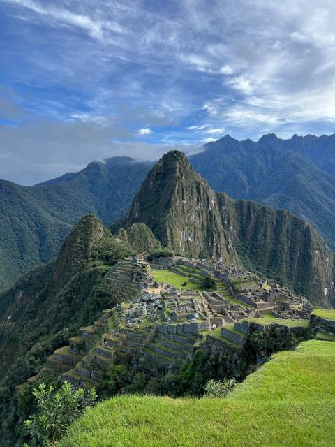 Machu Picchu ruins with mountainous backdrop.
