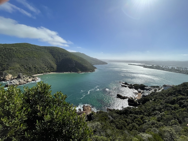 Scenic view of a bay with green hills and blue water.