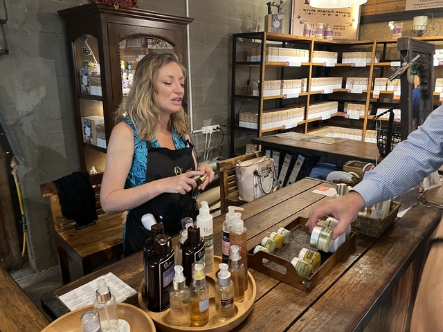       Person explaining products in a store.
  