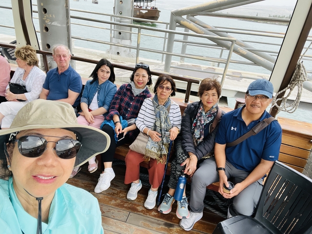       Group of people sitting on a boat.
  