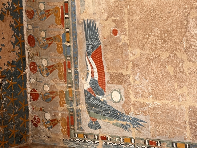       Ancient carved artwork on a stone wall.
  