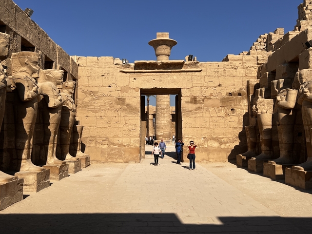      Giant statues and columns at an ancient Egyptian temple.
  