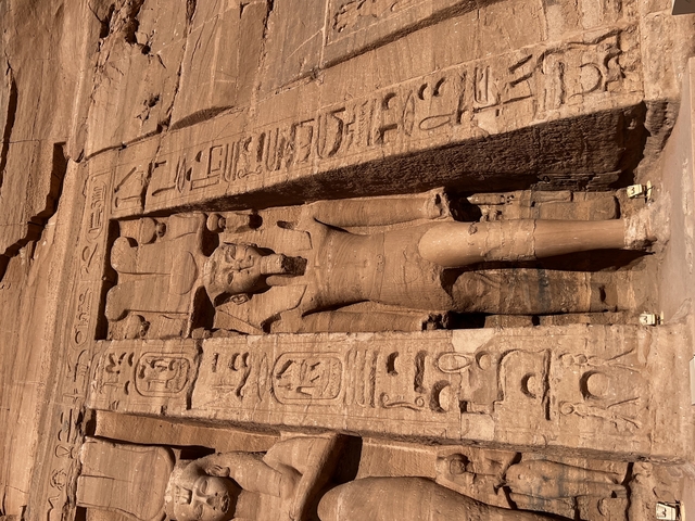       Ancient Egyptian carvings with hieroglyphs on a stone wall.
  