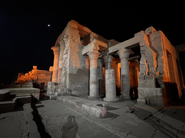       Ancient temple at night with moon visible.
  