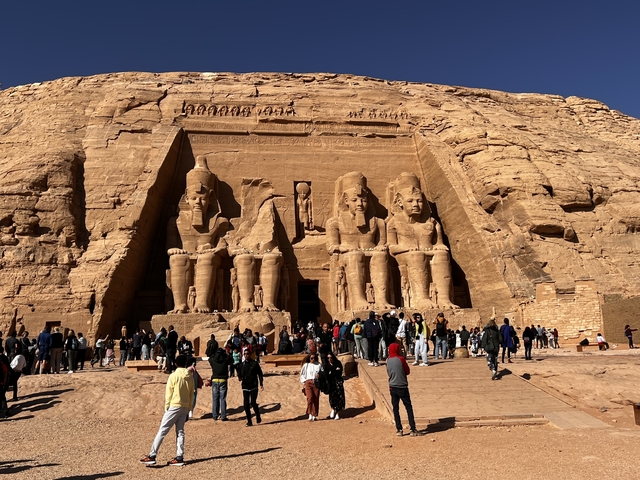       Pharaoh statues at Abu Simbel with tourists.
  