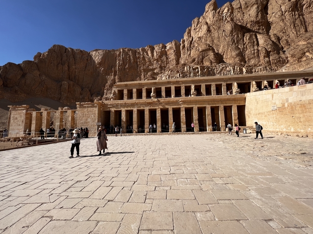       Panoramic view of an ancient temple complex with tourists.
  
