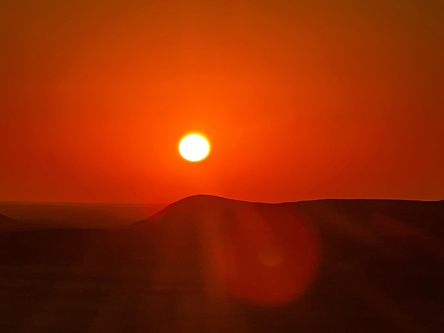       Sunset over desert hills.
  