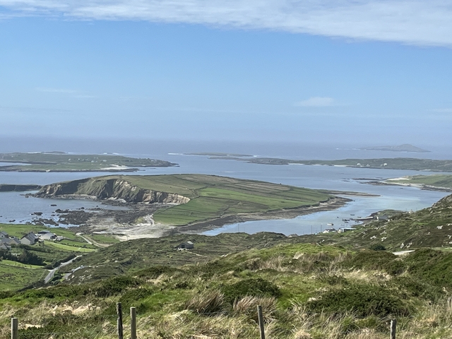 Scenic landscape with rolling hills and water.