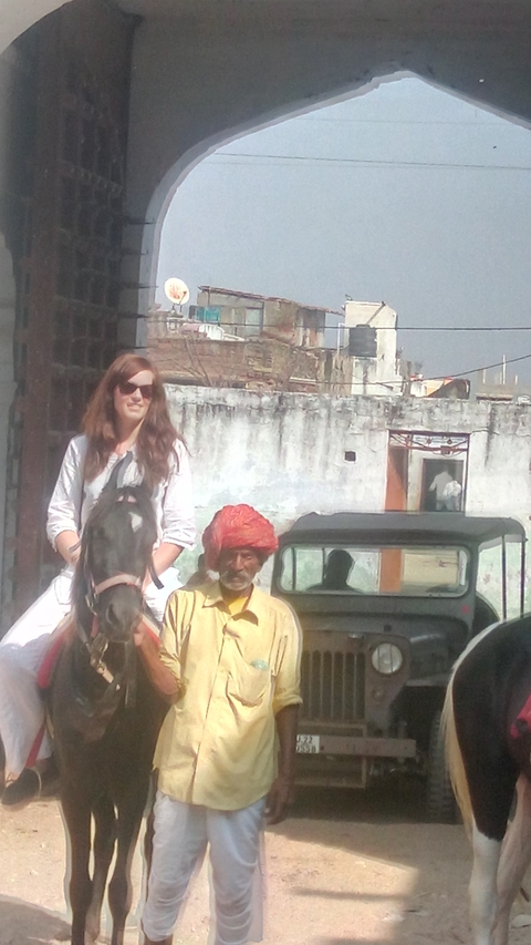      A person on horseback with a man in a turban standing next to them.
  