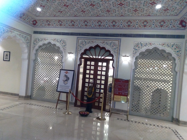       Interior of a decorated building with intricate patterns.
  
