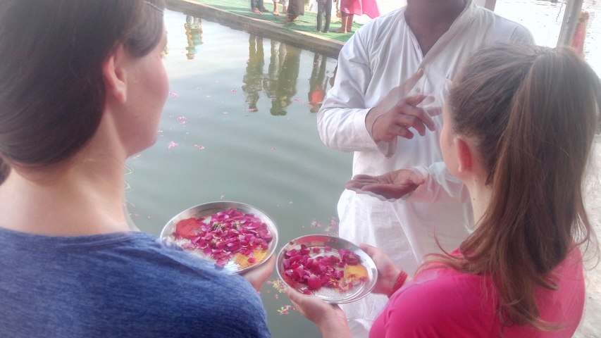       Close-up of decorative plates with people in a cultural exchange.
  