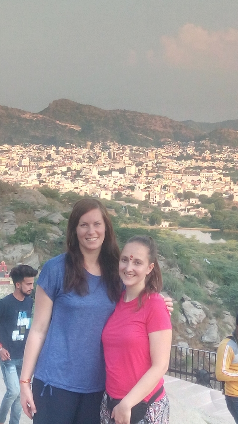       Two women with a cityscape in the background.
  