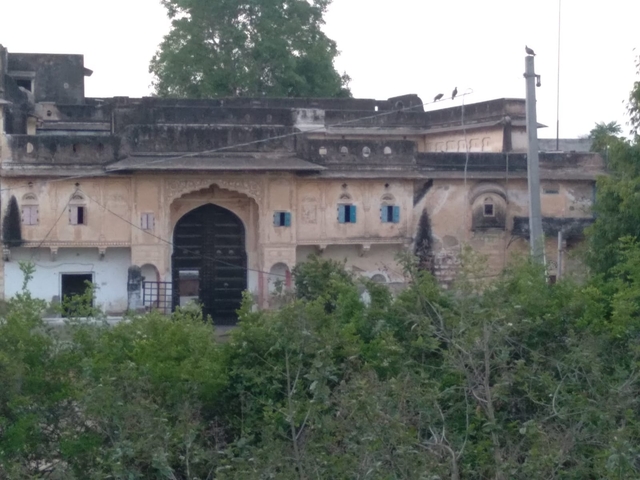       An old building with multiple arched doors and windows.
  