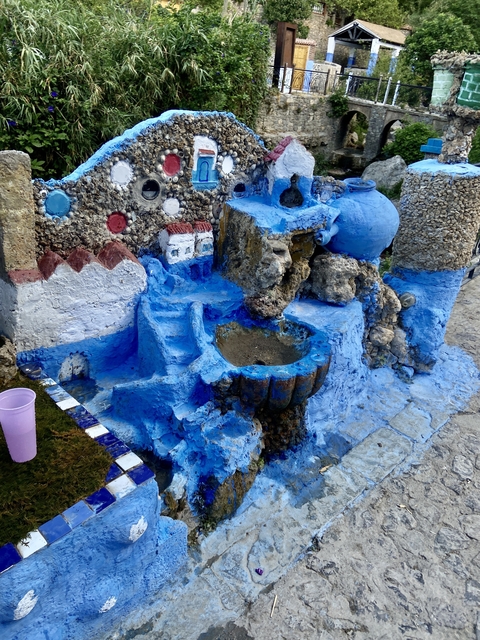       Small artistic stonework painted in blue with unique shapes.
  