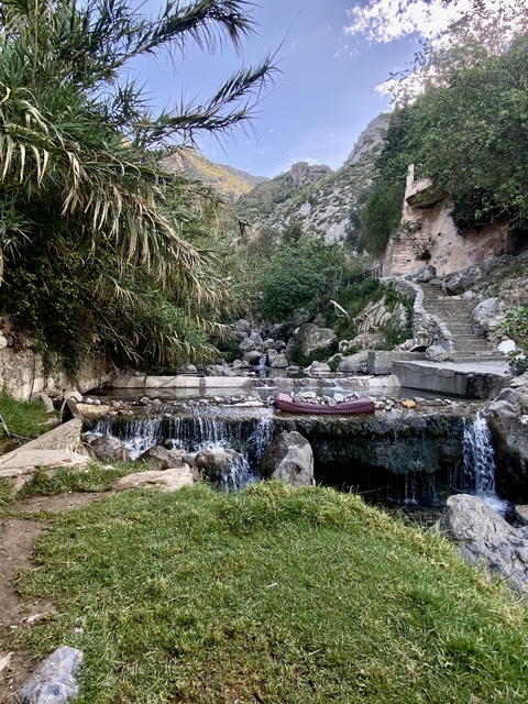       Waterway with natural surroundings and stone paths.
  
